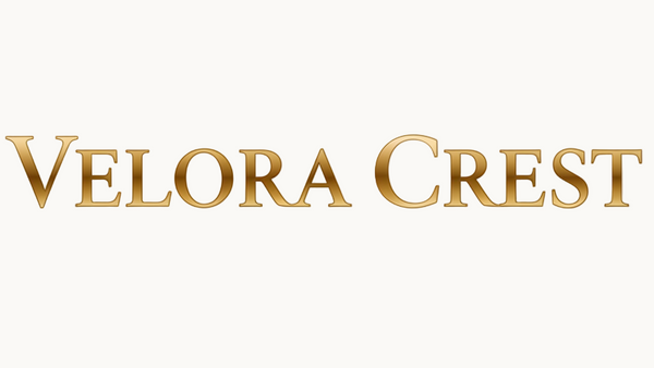 Create a sleek, luxurious wordmark logo that says Velora Crest in a horizontal layout. No icons or symbols, just the text. Use an elegant modern serif font similar to Dior or Cartier. Make the text metallic gold in the middle, fading softly to a lighter gold toward the edges for a premium gradient look. The background should be pure white, and the logo should feel minimal, timeless, and high-end — like a luxury fashion or jewelry brand.
